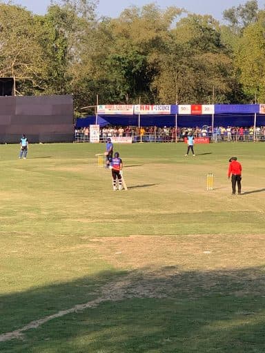 Local fixture underway with spectators along the rope