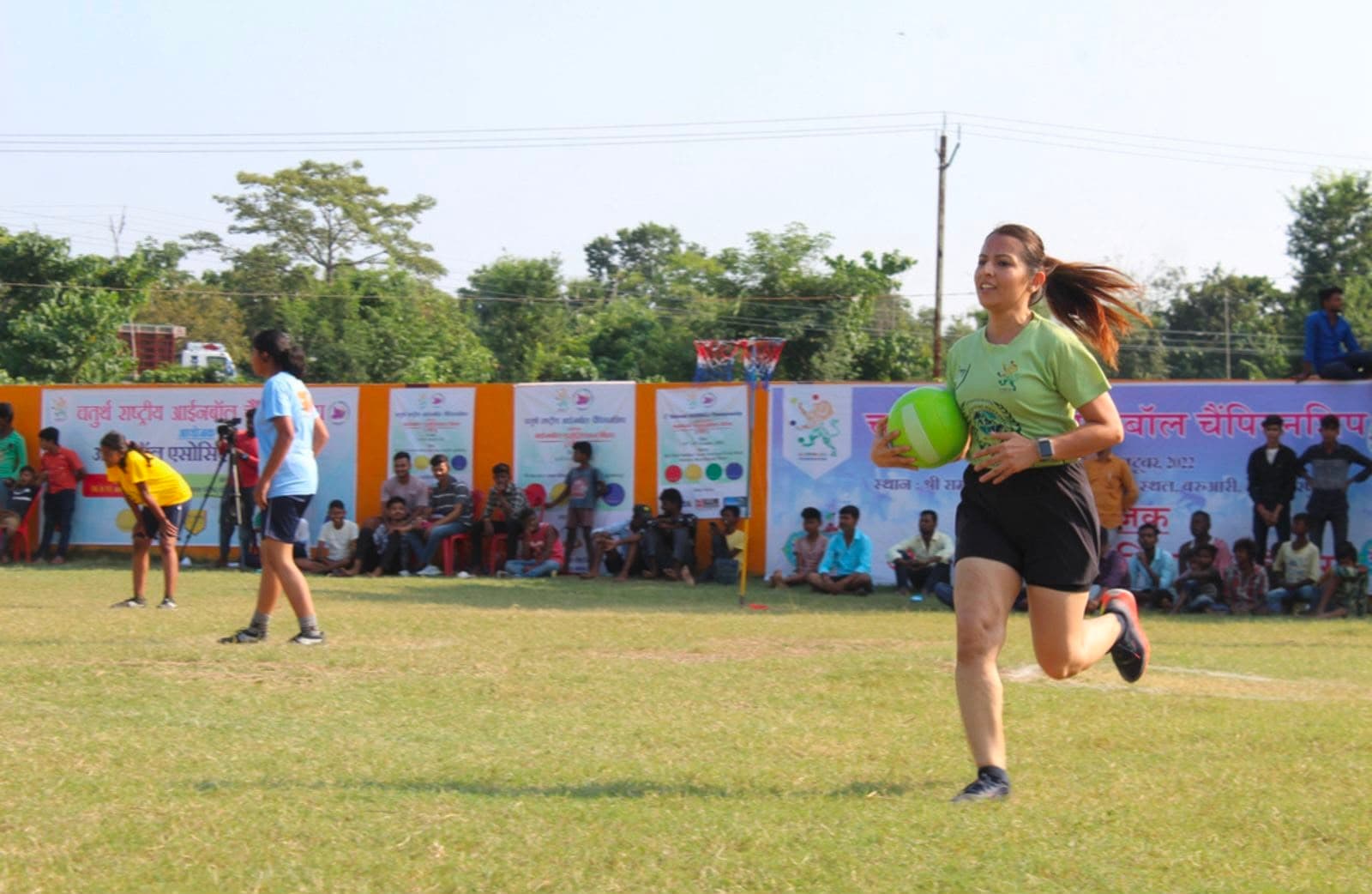 Player running with the ball at a grassroots netball championship