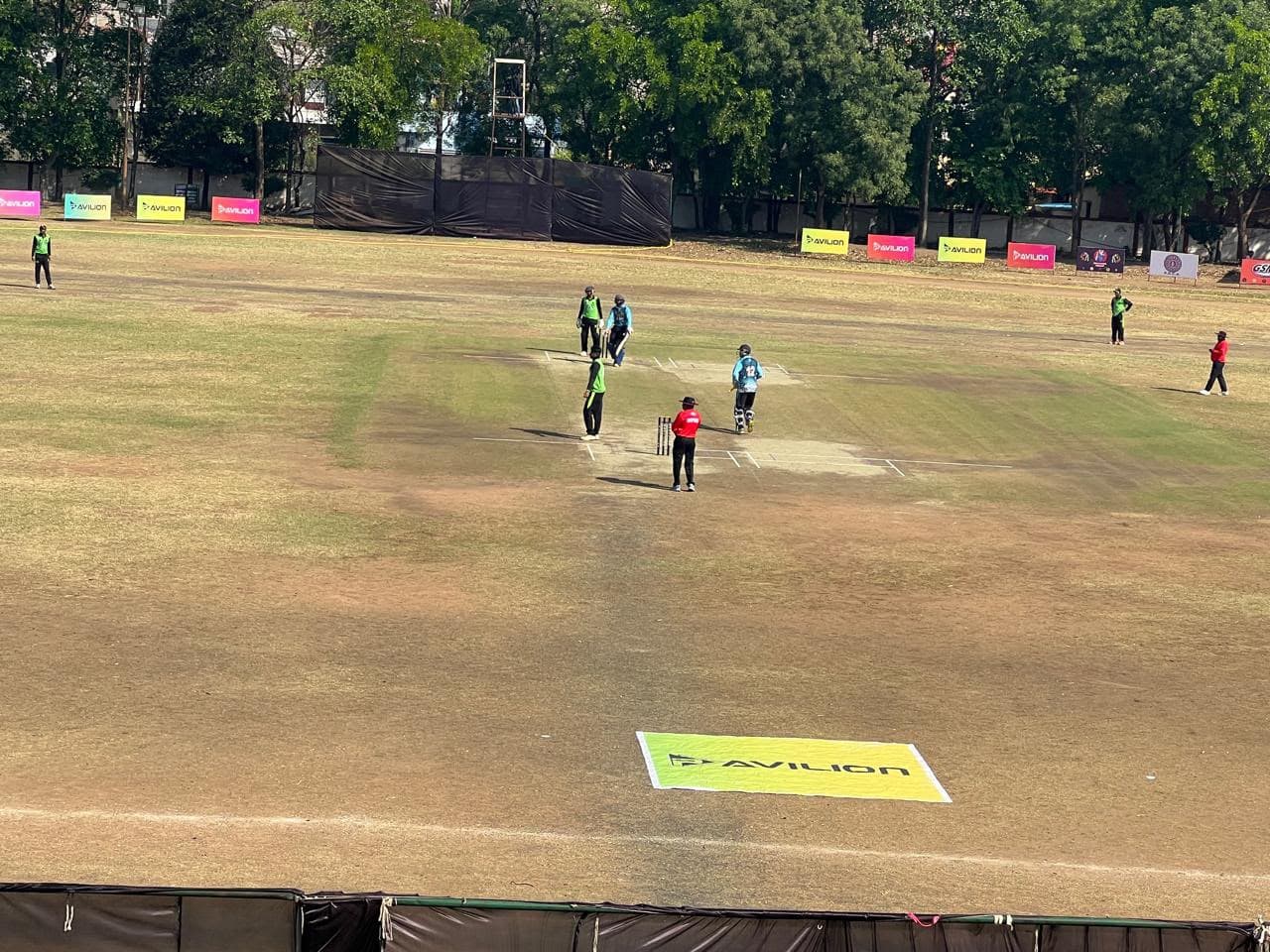 Wide shot of play underway at an Avilion-sponsored ground