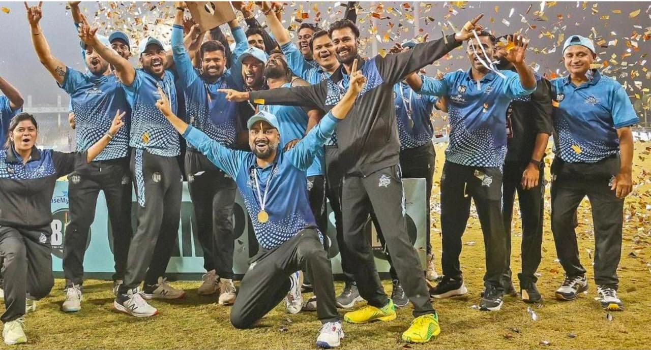 Champions squad celebrating with medals under confetti