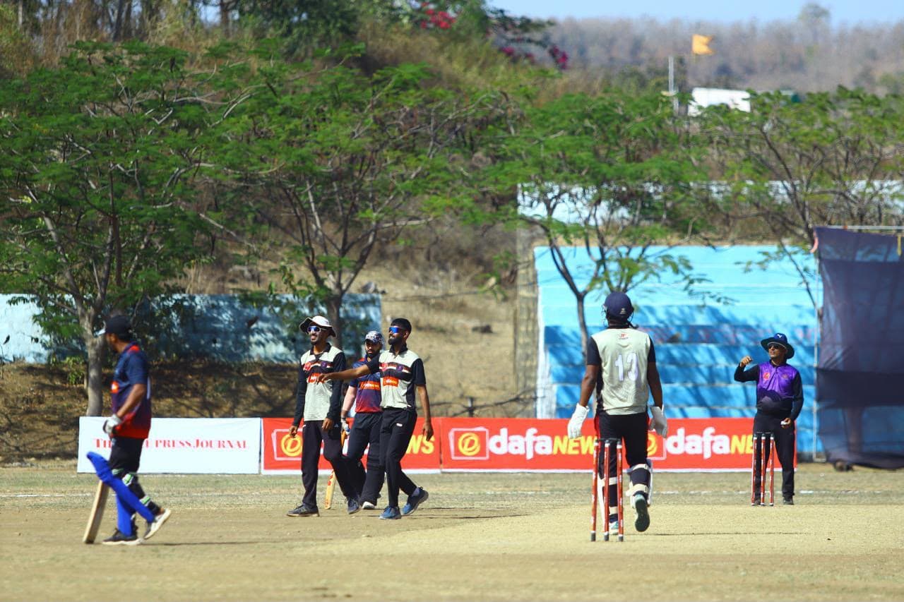 Fielders celebrating a dismissal on the boundary