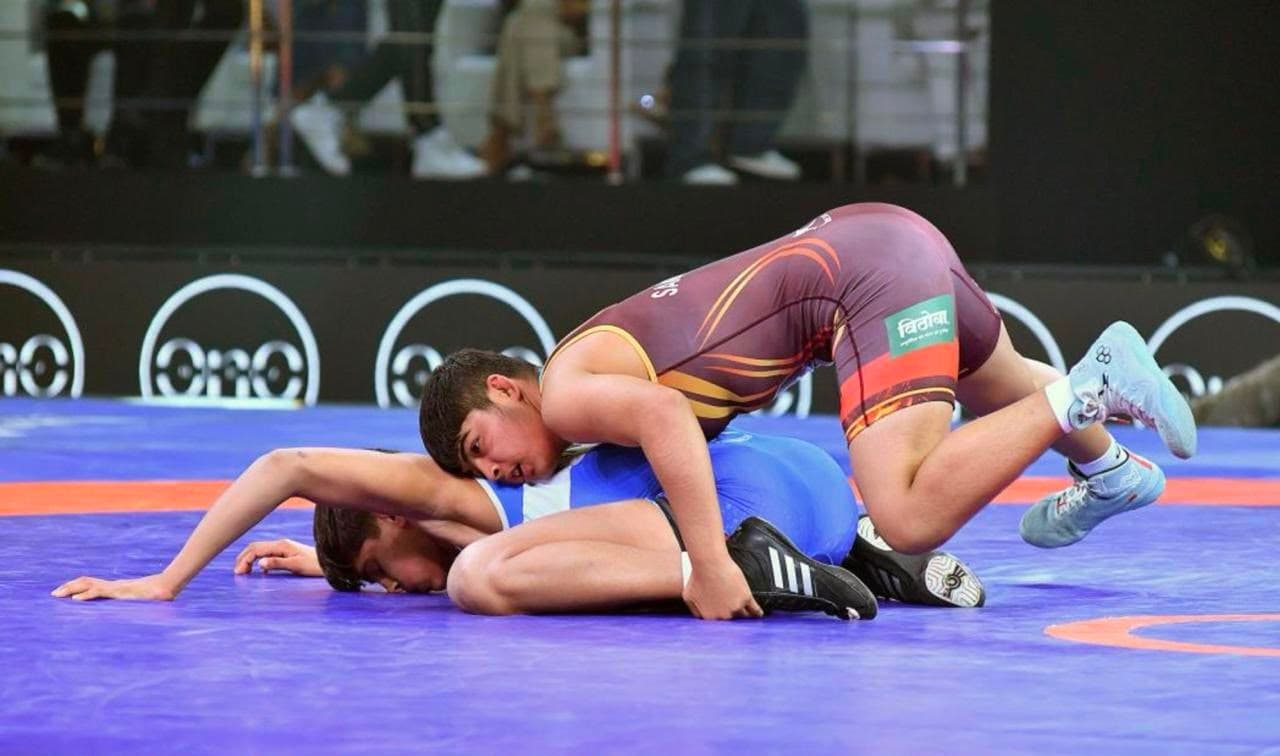 Wrestlers contesting a bout on the mat